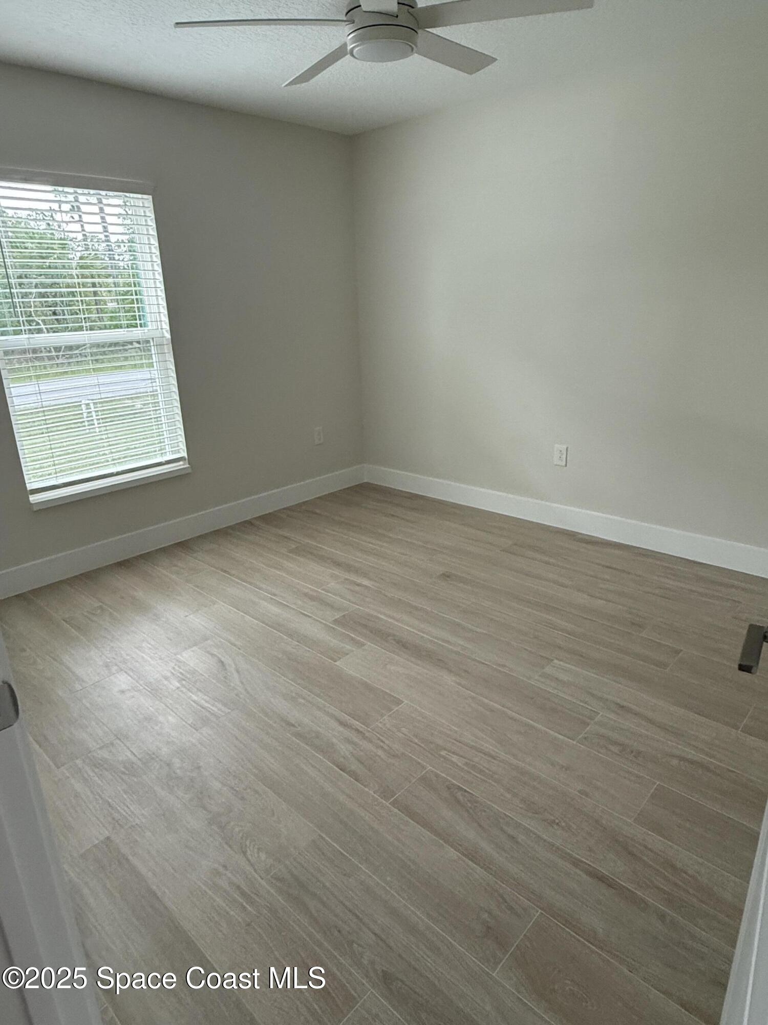 581 Toynbee Road Palm Bay, FL 32908 - Photo 20 of 25 an empty room with a window