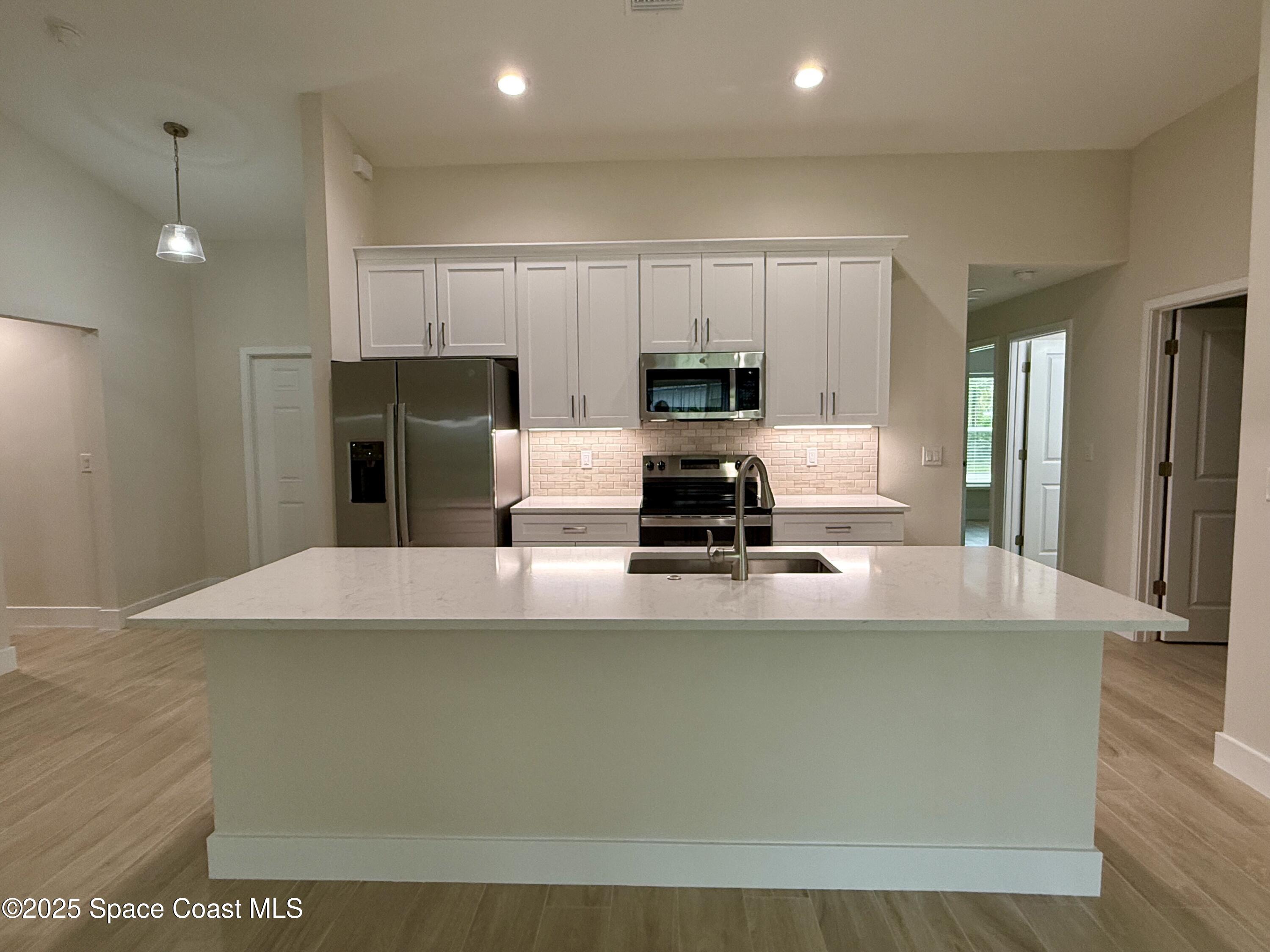 581 Toynbee Road Palm Bay, FL 32908 - Photo 5 of 25 a view of kitchen with stainless steel appliances cabinets