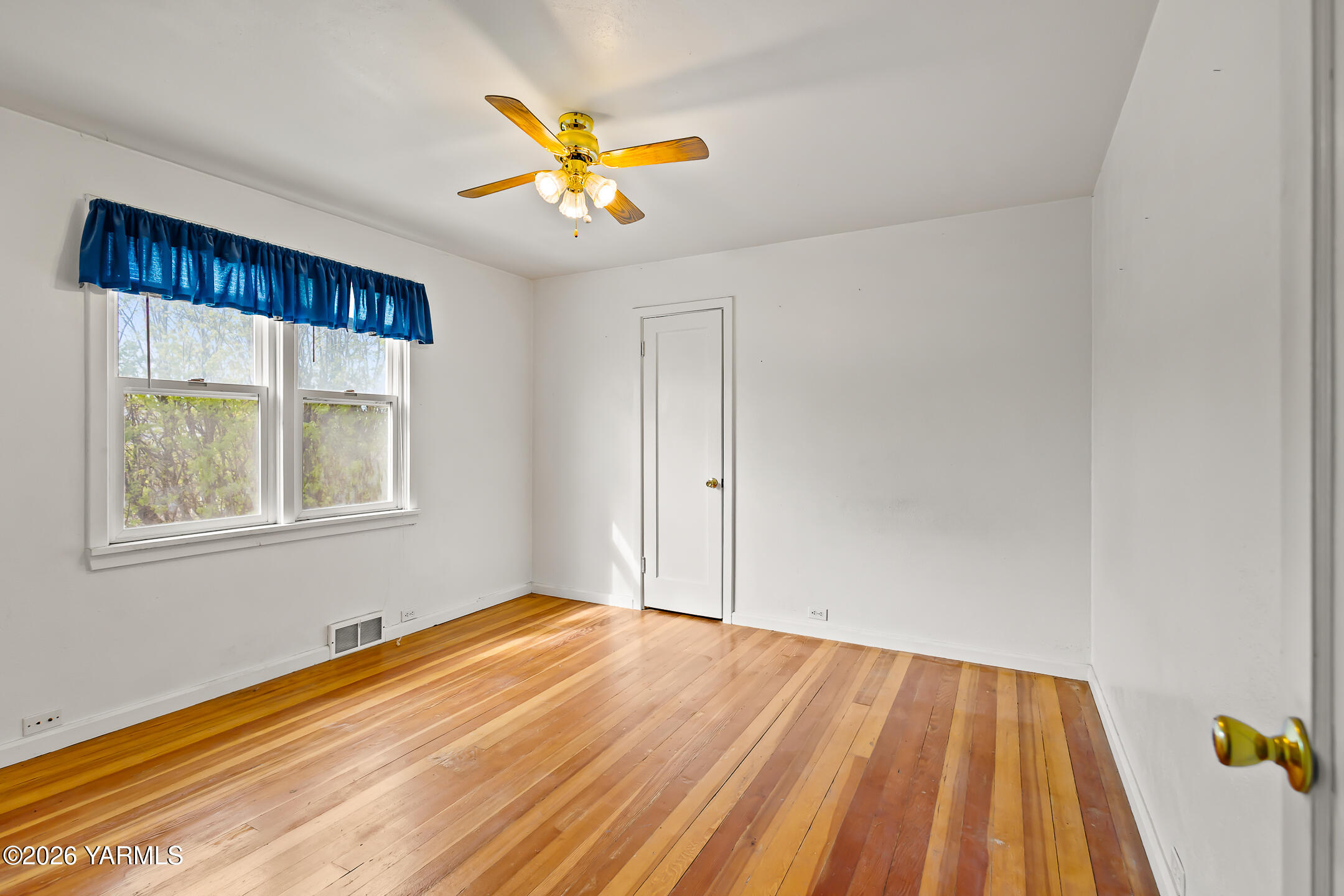 505 Schooley Road Zillah, WA 98953 - Photo 14 of 39 a view of an empty room with window and wooden floor