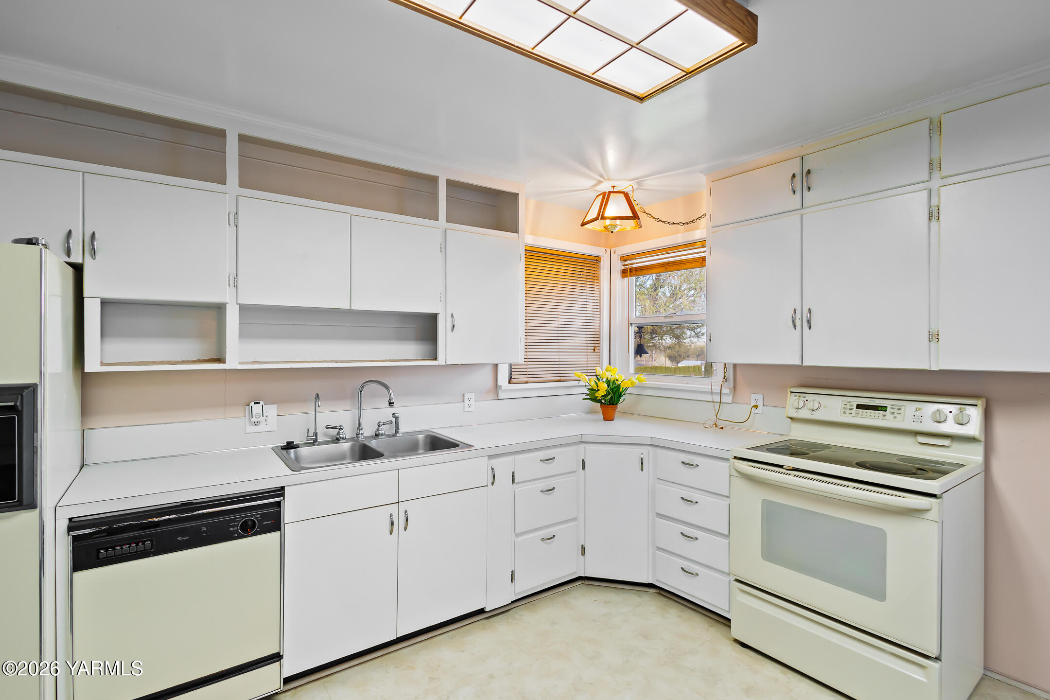 505 Schooley Road Zillah, WA 98953 - Photo 30 of 39 a kitchen with cabinets appliances a sink and a window