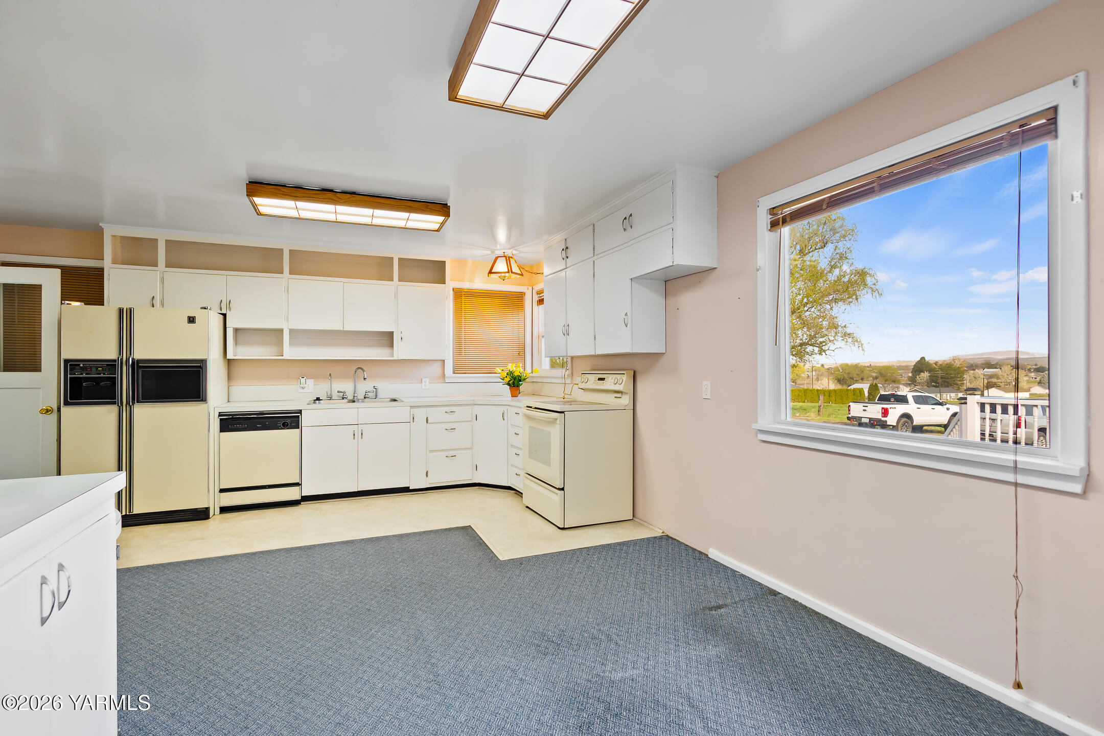 505 Schooley Road Zillah, WA 98953 - Photo 7 of 39 a kitchen with white cabinets and white appliances