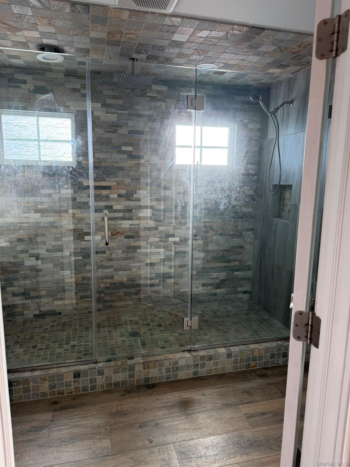 16 Cape Road Amityville, NY 11701 - Photo 16 of 27 Full bathroom featuring a stall shower and hardwood / wood-style flooring