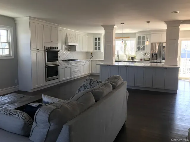 a living room with furniture and kitchen view