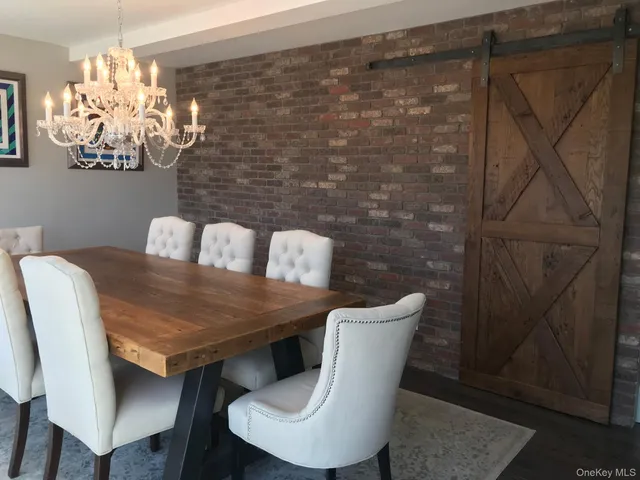a dining room with furniture and chandelier
