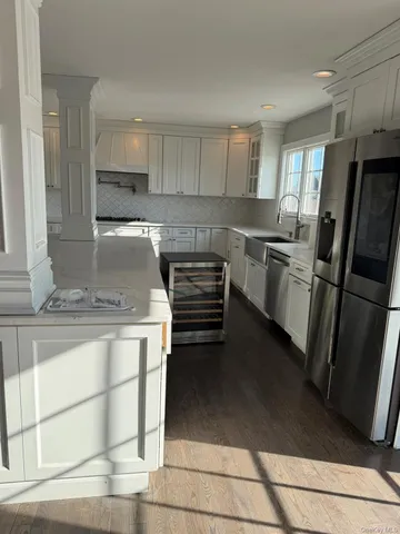 a kitchen with granite countertop a refrigerator and a sink
