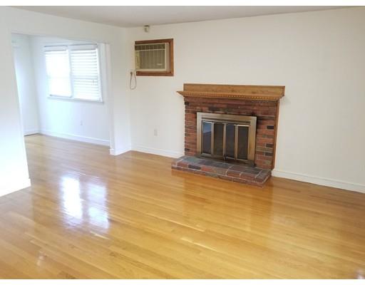34 Spallus Road Stoughton, MA 02072 - Photo 3 of 30 a view of empty room with wooden floor and fireplace