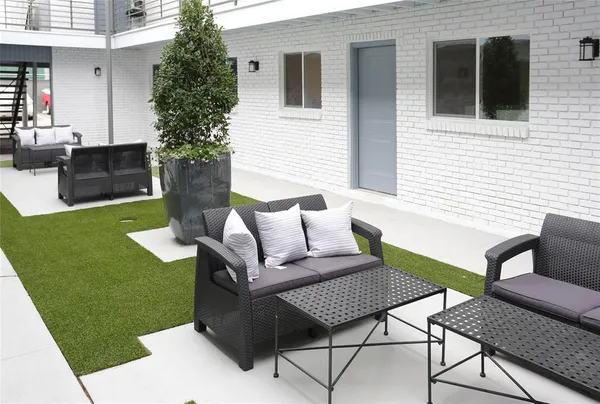 a view of a house with backyard sitting area