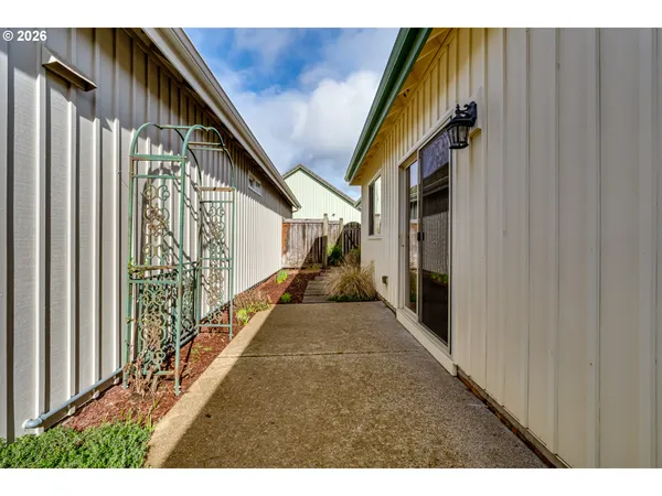 a view of garage yard and car parked on road