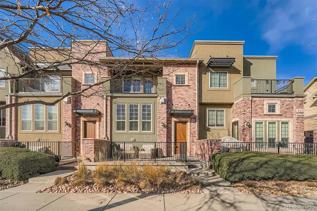 a front view of a residential apartment building with a yard