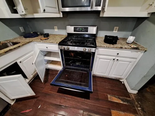 a stove top oven sitting inside of a kitchen