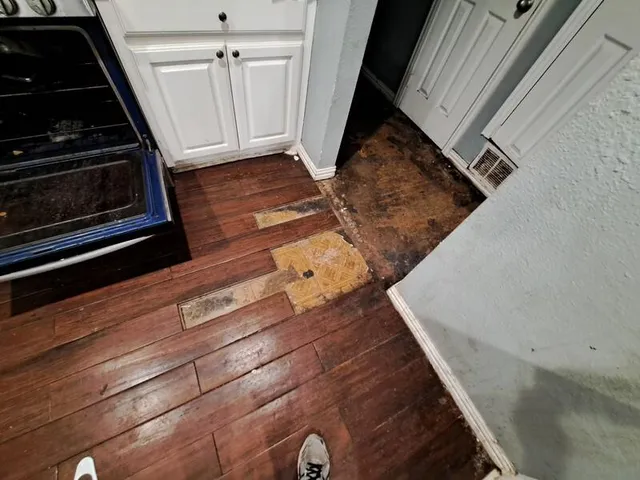 a view of an empty room and wooden floor