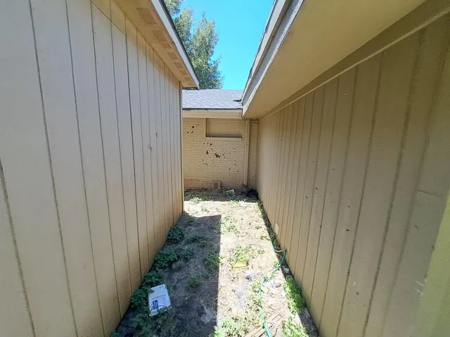 a view of a pathway gate with wooden walls