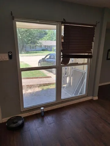 a room with wooden floor and a window