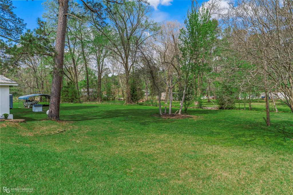 224 Prysock Road Doyline, LA 71023 - Photo 26 of 38 View of grassy yard featuring a detached carport