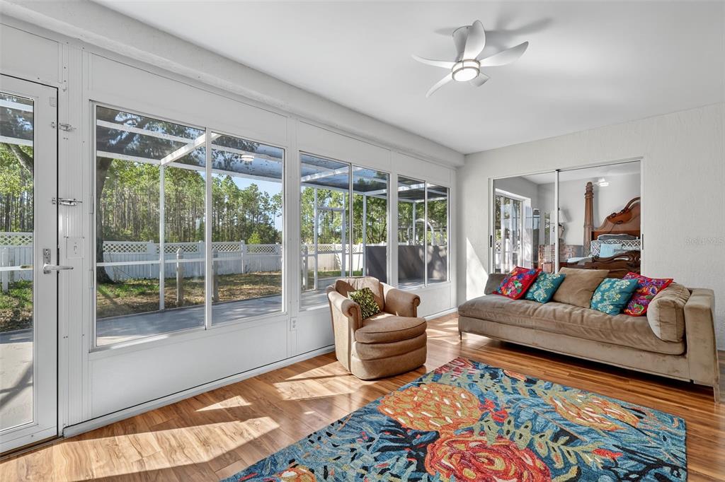 14520 Lost Lake Road Clermont, FL 34711 - Photo 17 of 47 a living room with furniture and a floor to ceiling window