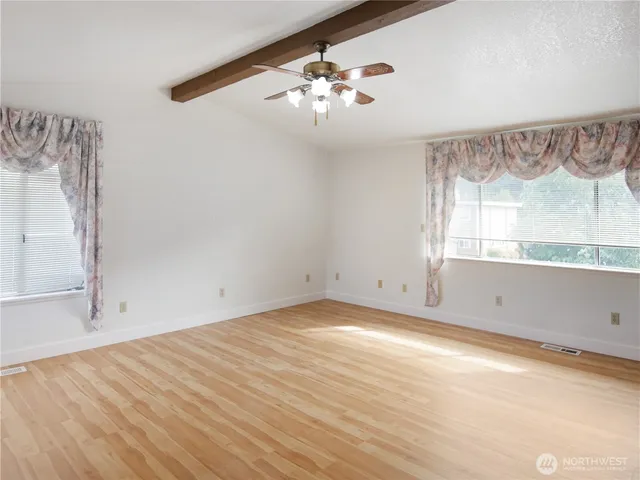 a view of room with window and hardwood floor