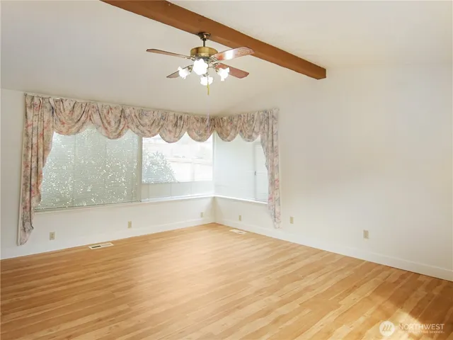 wooden floor in an empty room with a fireplace