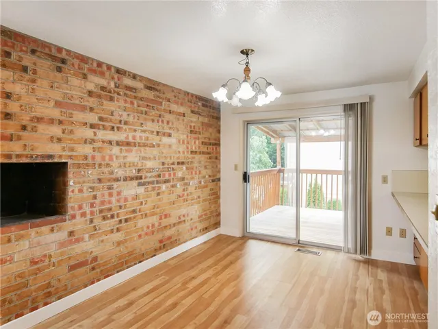 a kitchen with a sink cabinets and wooden floor