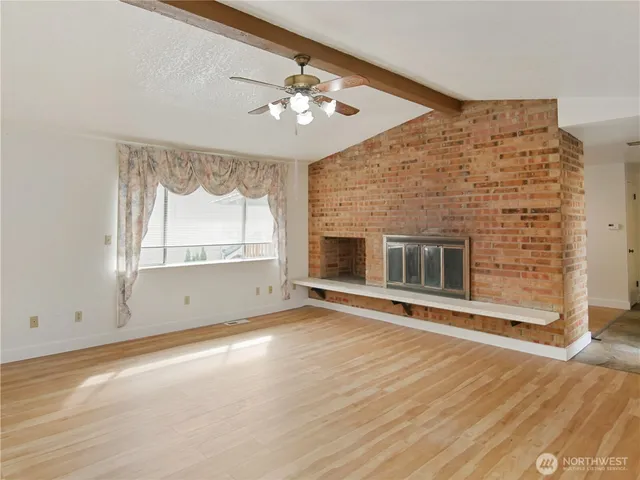an empty room with windows and closet