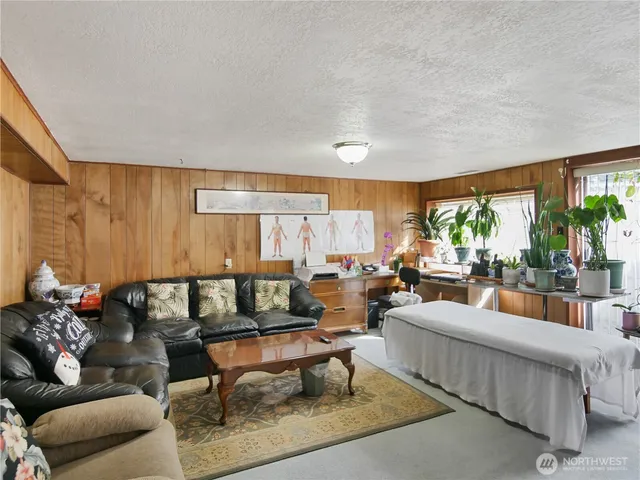 a living room with furniture a rug and a window