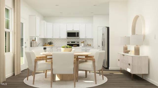 a kitchen with stainless steel appliances white cabinets and wooden floor