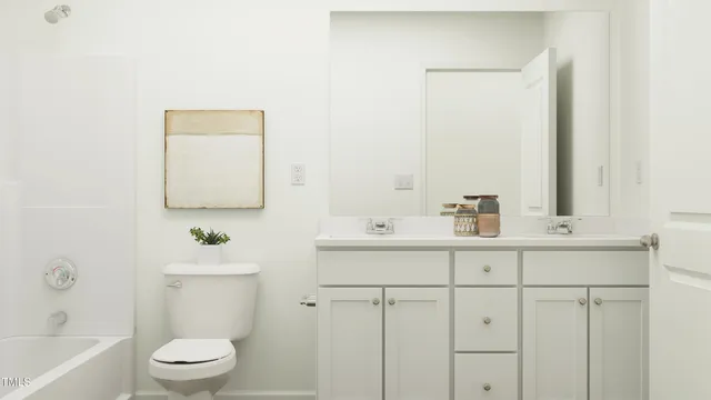 a bathroom with a sink a toilet and mirror