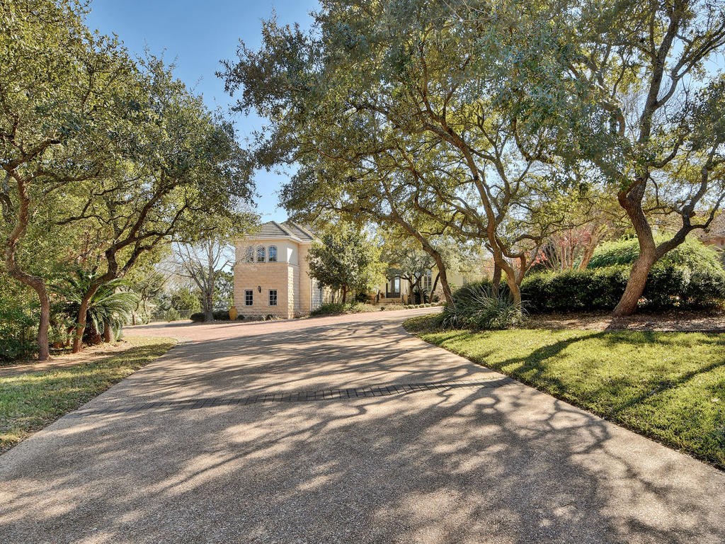 16 Pascal Lane Austin, TX 78746 - Photo 1 of 1 a view of white house with a yard and large trees
