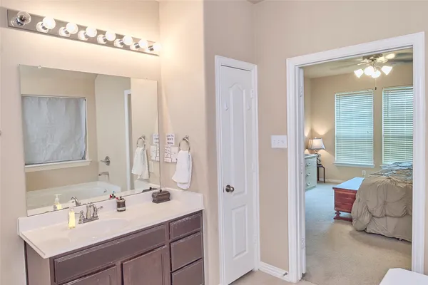 a en suite bathroom with a sink double vanity and a mirror