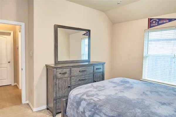 a bedroom with a bed and a dresser