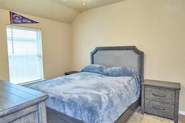 a bedroom with a bed and a dresser