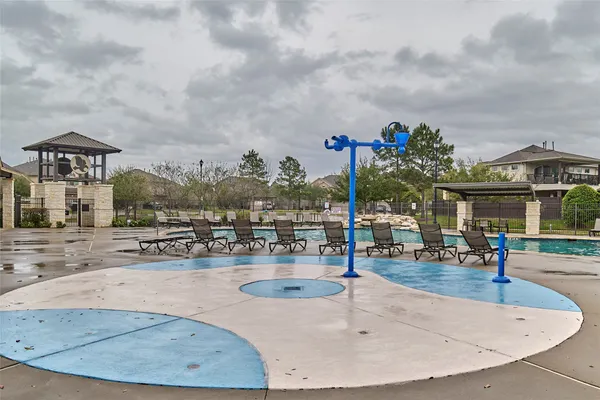 an outdoor space with swimming pool and seating