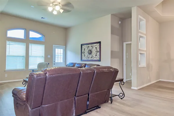 a bed room with furniture and wooden floor
