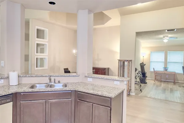 a spacious bathroom with a granite countertop sink and a mirror