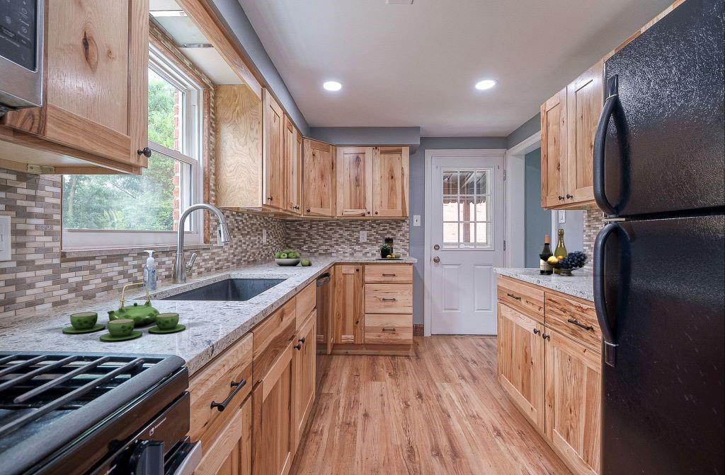 1015 McNeilly Road Pittsburgh, PA 15226 - Photo 11 of 29 a kitchen with stainless steel appliances a sink cabinets and wooden floor
