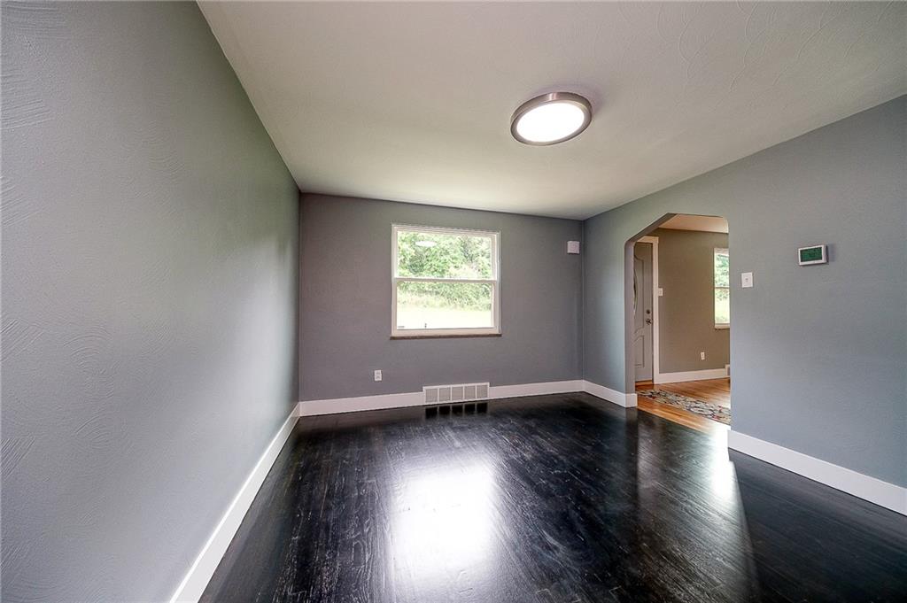 1015 McNeilly Road Pittsburgh, PA 15226 - Photo 7 of 29 an empty room with wooden floor and windows