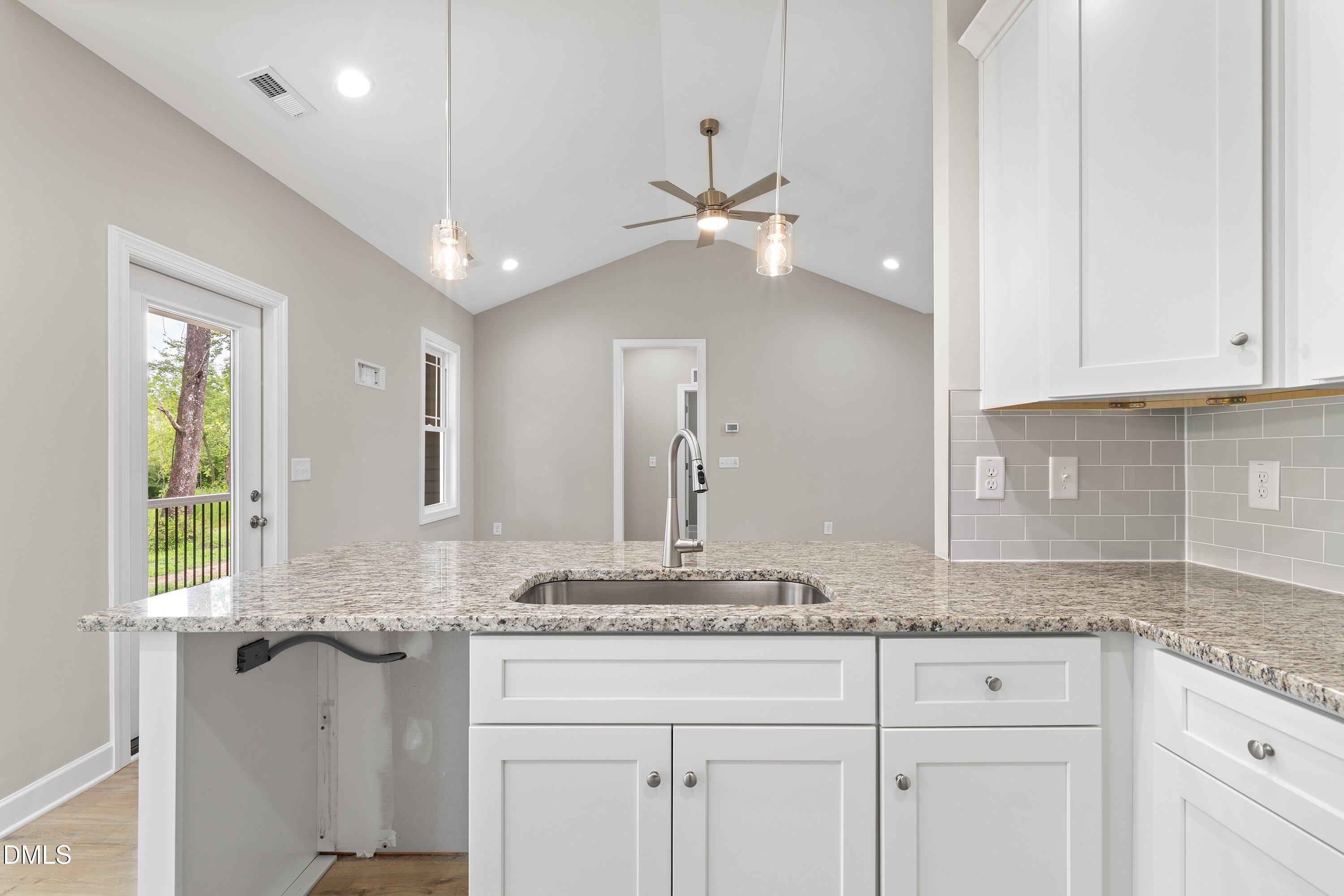 1115 Nor-Am Road Pikeville, NC 27863 - Photo 16 of 40 a bathroom with granite countertop a sink a vanity and window