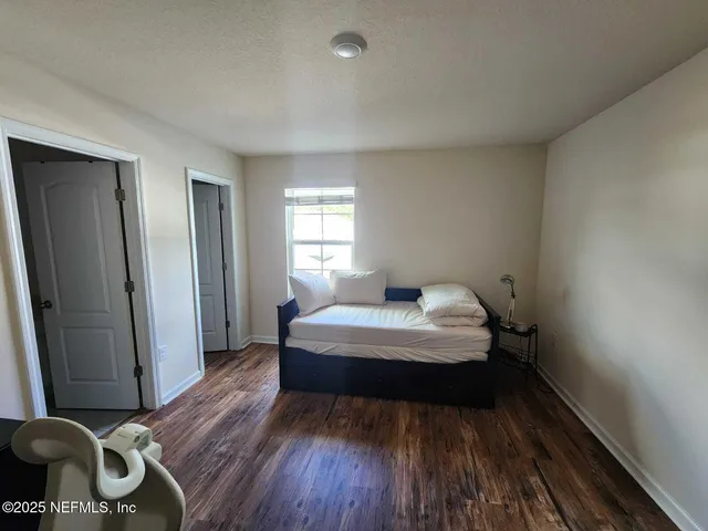 a bedroom with a bed and a chair