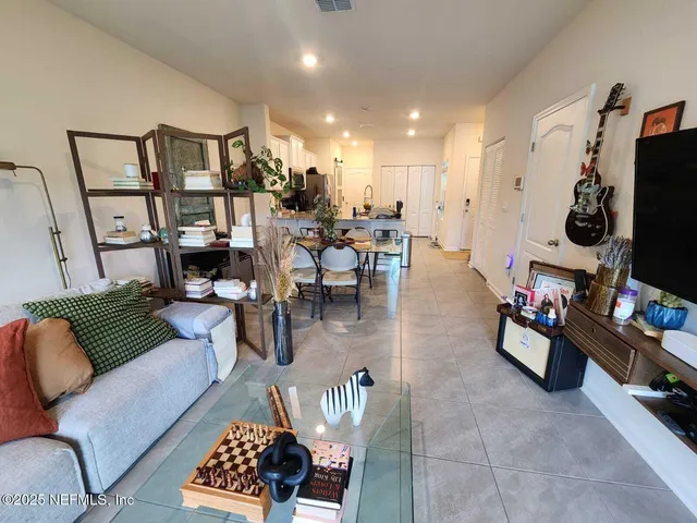 a kitchen with stainless steel appliances granite countertop a stove a sink a microwave and a refrigerator