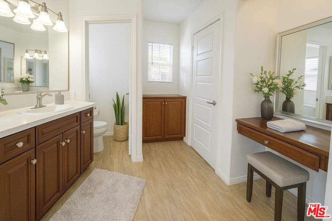 13233 Stanton Drive Rancho Cucamonga, CA 91739 - Photo 26 of 39 a spacious bathroom with a granite countertop sink a toilet a mirror and vanity