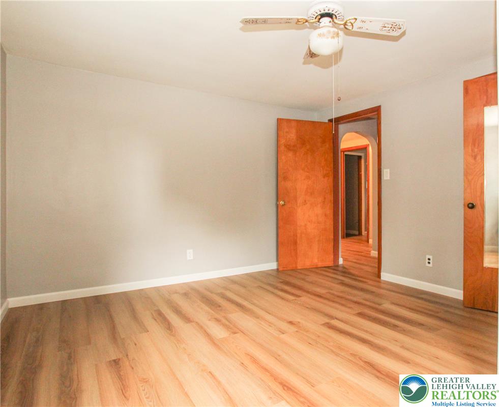 492 Filetown Road Nazareth, PA 18064 - Photo 16 of 30 Warm wood-toned flooring flows through this inviting bedroom, complete with a classic ceiling fan.