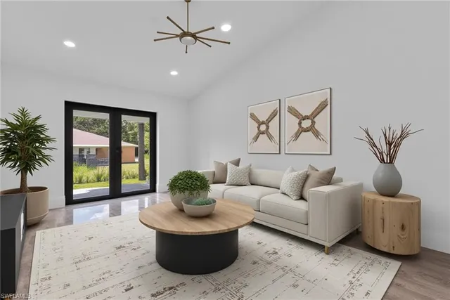a living room with furniture and a potted plant