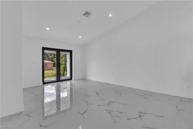 a view of an empty room with a window