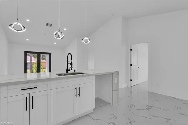 a kitchen with a sink and cabinets