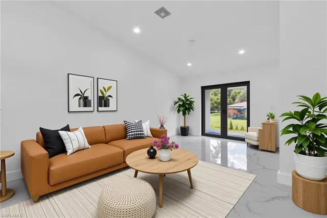 a living room with furniture and a potted plant