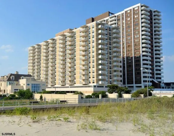 a blue swimming pool with buildings in the background