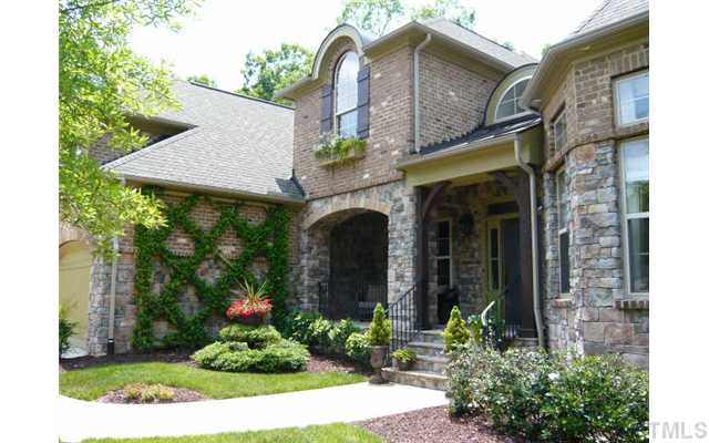 421 Rensford Place Cary, NC 27513 - Photo 2 of 25 a front view of a house with garden