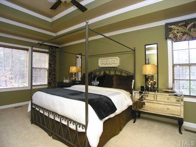 421 Rensford Place Cary, NC 27513 - Photo 11 of 25 a bed sitting in a bedroom next to a window