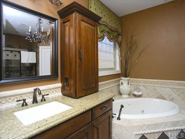 421 Rensford Place Cary, NC 27513 - Photo 12 of 25 a bathroom with a granite countertop sink and a mirror
