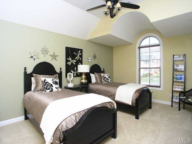 421 Rensford Place Cary, NC 27513 - Photo 15 of 25 a bedroom with bed and a chandelier