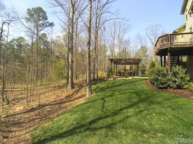 421 Rensford Place Cary, NC 27513 - Photo 21 of 25 a view of a yard with plants and large trees